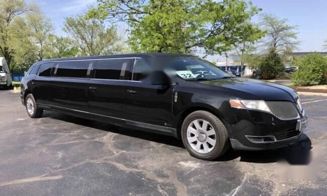 Black Lincoln stretch limousine, full side exterior, Montreal