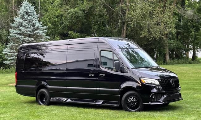 Black Mercedes-Benz Sprinter van, full side exterior, Montreal